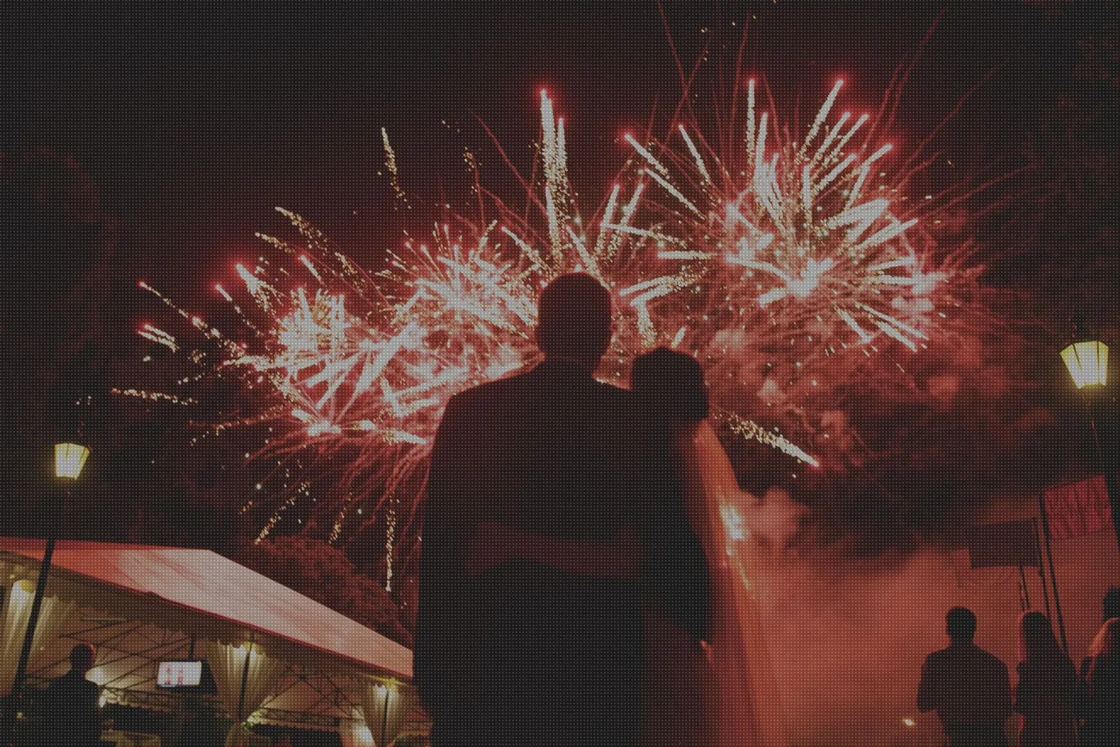 A couple watching a firework display at their wedding